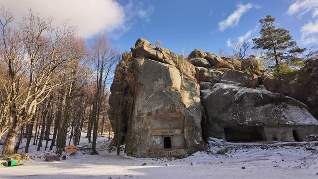 ancient cave monastery in the Carpathians in Bubnyshche, Ukraine, which is hundreds of years old, and the Dovbush rocks are millions of years old. Time lapse with clouds that symbolize transience
