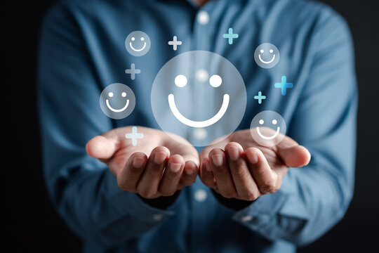 Hands holding happy smile face. mental health positive thinking and growth mindset, mental health care recovery to happiness emotion..