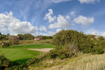 Fototapeta premium view from Hiking Trail on Dike to Golf Course in Sankt Peter-Ording,Eiderstedt Peninsula,North Sea,North Frisia,Germany