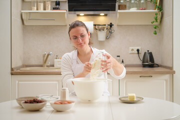 Woman preparing dough in the kitchen at home. Healthy food concept. Process of cooking pecan pie in home kitchen for American Thanksgiving Day.