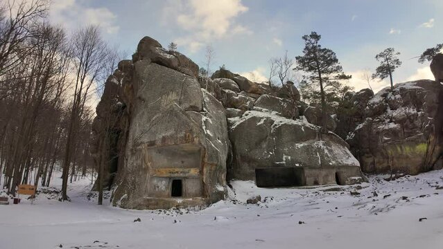 ancient cave monastery in the Carpathians in Bubnyshche, Ukraine, which is hundreds of years old, and the Dovbush rocks are millions of years old. Time lapse with clouds that symbolize transience