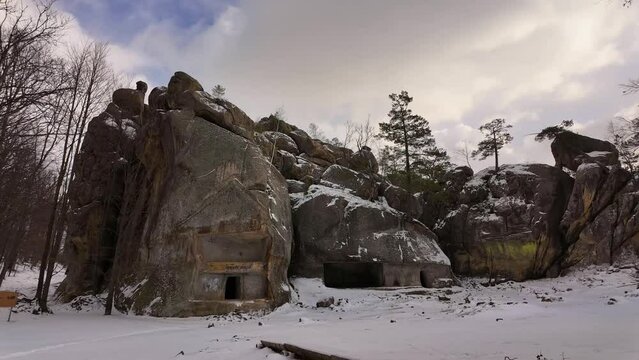 ancient cave monastery in the Carpathians in Bubnyshche, Ukraine, which is hundreds of years old, and the Dovbush rocks are millions of years old. Time lapse with clouds that symbolize transience