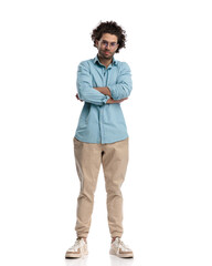 Fototapeta premium confident and handsome casual man standing with arms crossed