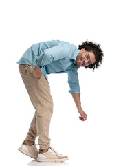 joyful casual man raising something from the ground