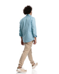 back view of casual man walking to side