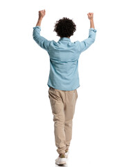 rear view of casual man holding fists in the air