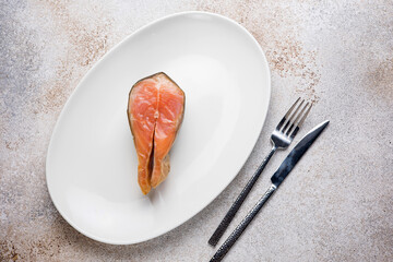 Salted salmon steak on a plate. Close up