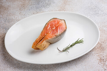 Salted salmon steak on a plate. Close up