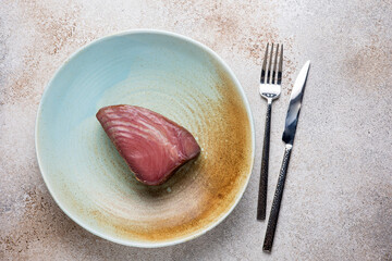 Cold smoked tuna on a plate. Close up