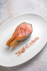Salted salmon steak on a plate. Close up