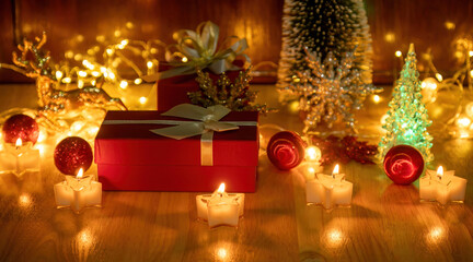 Fototapeta na wymiar Red gift box and candlelight on a wooden table.