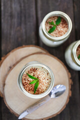 Tiramisu on wooden table with mint