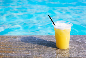 Glass of tropical cocktail on poolside