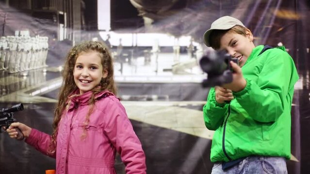 Boy and girl with guns 