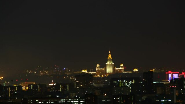 Fireworks over night city with the Moscow State University in center