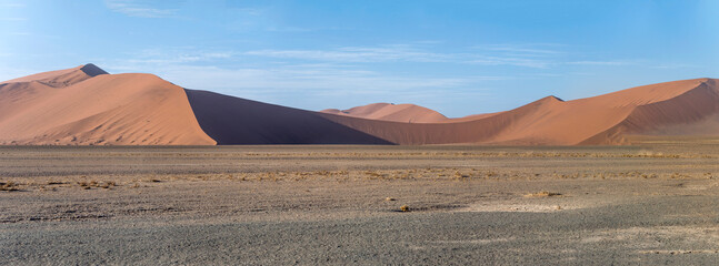 Fototapeta na wymiar light and shadow on multiple slopes of red dunes, Naukluft desert near Sossusvlei, Namibia