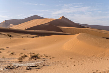 Fototapeta na wymiar tourists on path to Deadlvei, Naukluft desert near Sossusvlei, Namibia