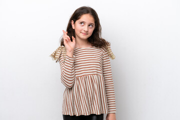 Little girl isolated on white background with fingers crossing and wishing the best