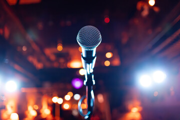 Microphone on stage against a background of auditorium. - 714640978