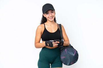 Young sport woman with sport bag isolated on white background sending a message with the mobile