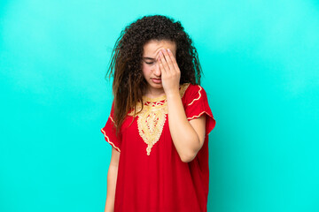 Young Arab woman isolated on blue background with headache