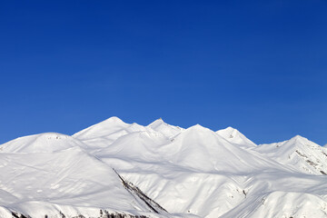 Snowy mountains and blue sky - 714643156