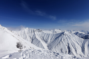 Winter mountains and blue sky - 714644332