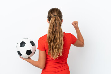 Little caucasian girl isolated on white background with soccer ball