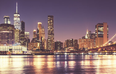 Obraz premium Manhattan waterfront skyline at night, color toning applied, New York City, USA.