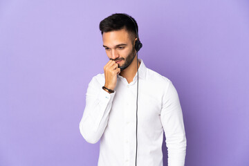 Telemarketer man working with a headset isolated on purple background having doubts