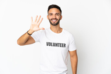 Young caucasian volunteer man isolated on white background counting five with fingers