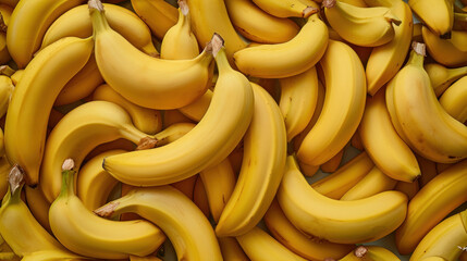  a large pile of ripe bananas sitting on top of a pile of other bananas in a pile on top of a pile of other bananas on top of a table. - obrazy, fototapety, plakaty