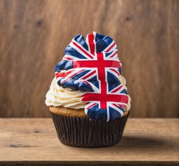 Cupcake with United Kingdom flag on top on wooden background.
