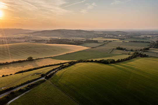 Summer aerial drone landscape image of English countryside surrounding Firle Beacon in South Downs National Park