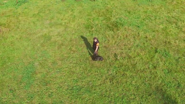 Man trains doberman at autumn sunny day(models with release)
