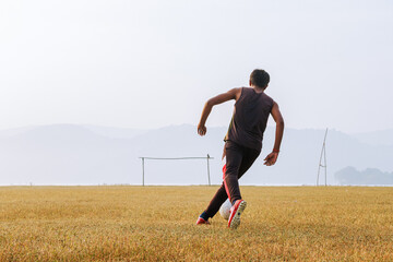 Running Soccer Football Player. Young Indian Footballer Kicking Football Match game. Young Soccer Players Running After the Ball