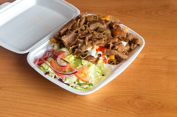 Kebab in a Styrofoam takeaway package. Kebab with beef meat.