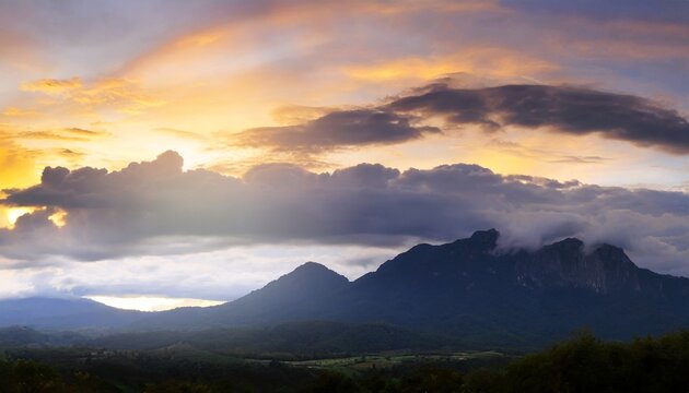 evening time of panorama mountain under dramatic twilight sky and cloud nightfall silhouette mountain on sunset