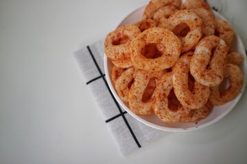Krupuk setan or hot spicy ring shaped snack. Crispy snack with chilli powder. very hot and spicy.
