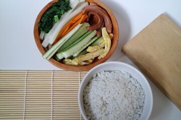 Home Making gimbab. Gimbap is a Korean food made from steamed white rice and various vegetables, fish or meat and other ingredients such as sesame oil and sauce, rolled in nori.