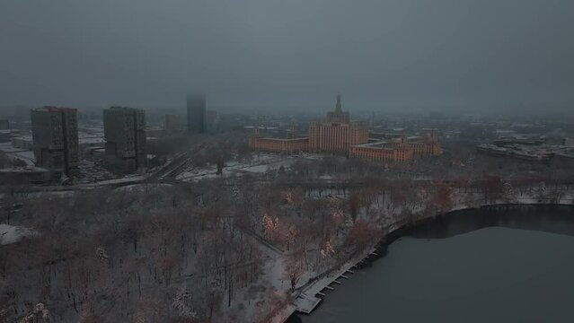 Sunrise over Bucharest. 4K aerial video during a winter sunrise over Herastrau Park and Lake, next to Free Press House (Casa Presei Libere in Romanian language). Travel to Romania.