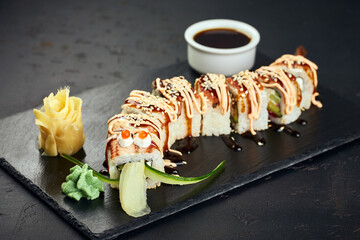 Roll made of Fresh Raw Salmon, Smoked Eel, Cream Cheese and Avocado inside. Topped with Smoked Eel unagi