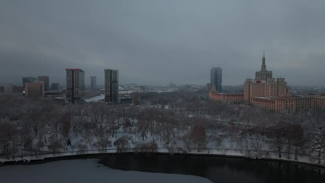 Sunrise over Bucharest. 4K aerial video during a winter sunrise over Herastrau Park and Lake, next to Free Press House (Casa Presei Libere in Romanian language). Travel to Romania.