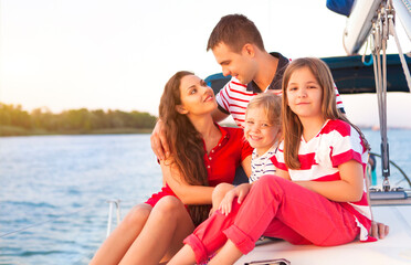Beautiful family with two daughters having great time at the yacht