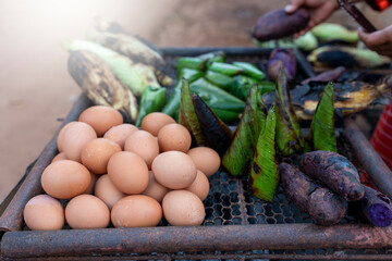 Stacking eggs and purple yam on the grilled.