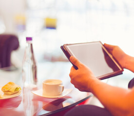 Fototapeta na wymiar Man holding tablet computer in cafe