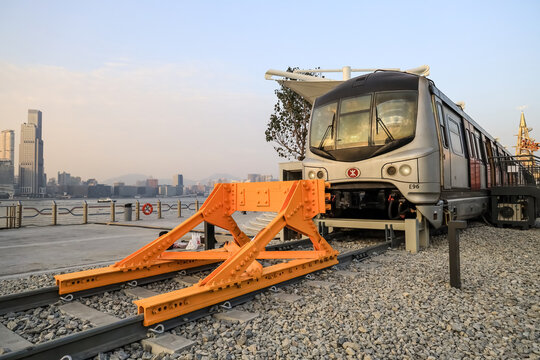 Old fashioned train terminated at buffer stop, urban backdrop Jan 12 2024