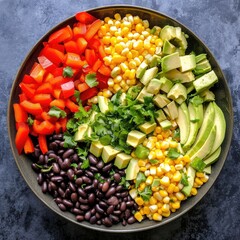 A southwest black bean salad with black beans, corn, avocado, bell peppers, and a spicy chipotle lime dressing