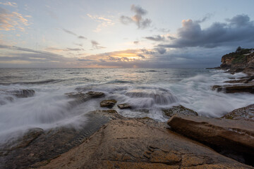 Wave flowing over the rock on the coastline.