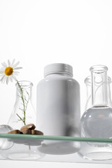 A white jar with vitamins or herbal medicines on a glass shelf. Medicines